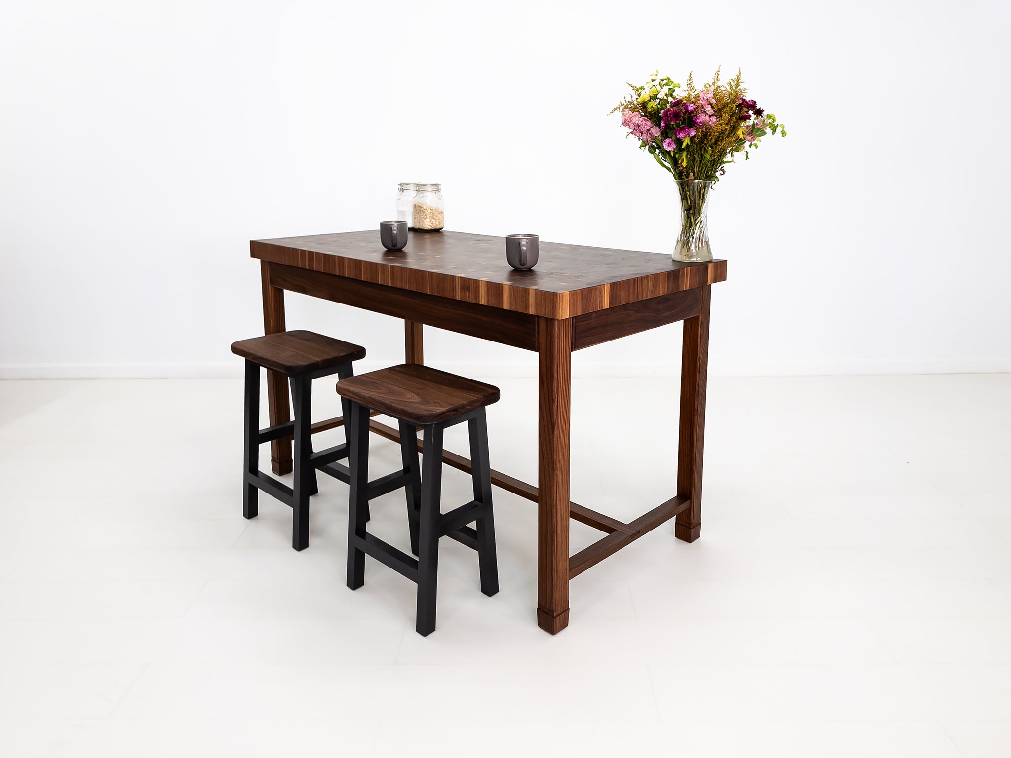 CAMI butcher block island in solid walnut with end-grain top and stretcher base.
