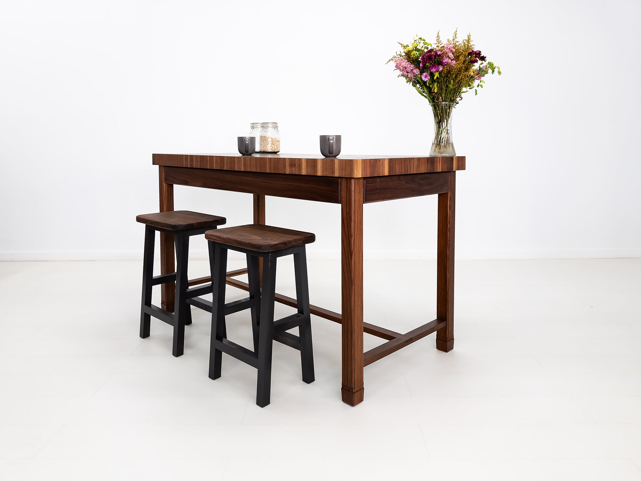 CAMI butcher block island in solid walnut with end-grain top and stretcher base.