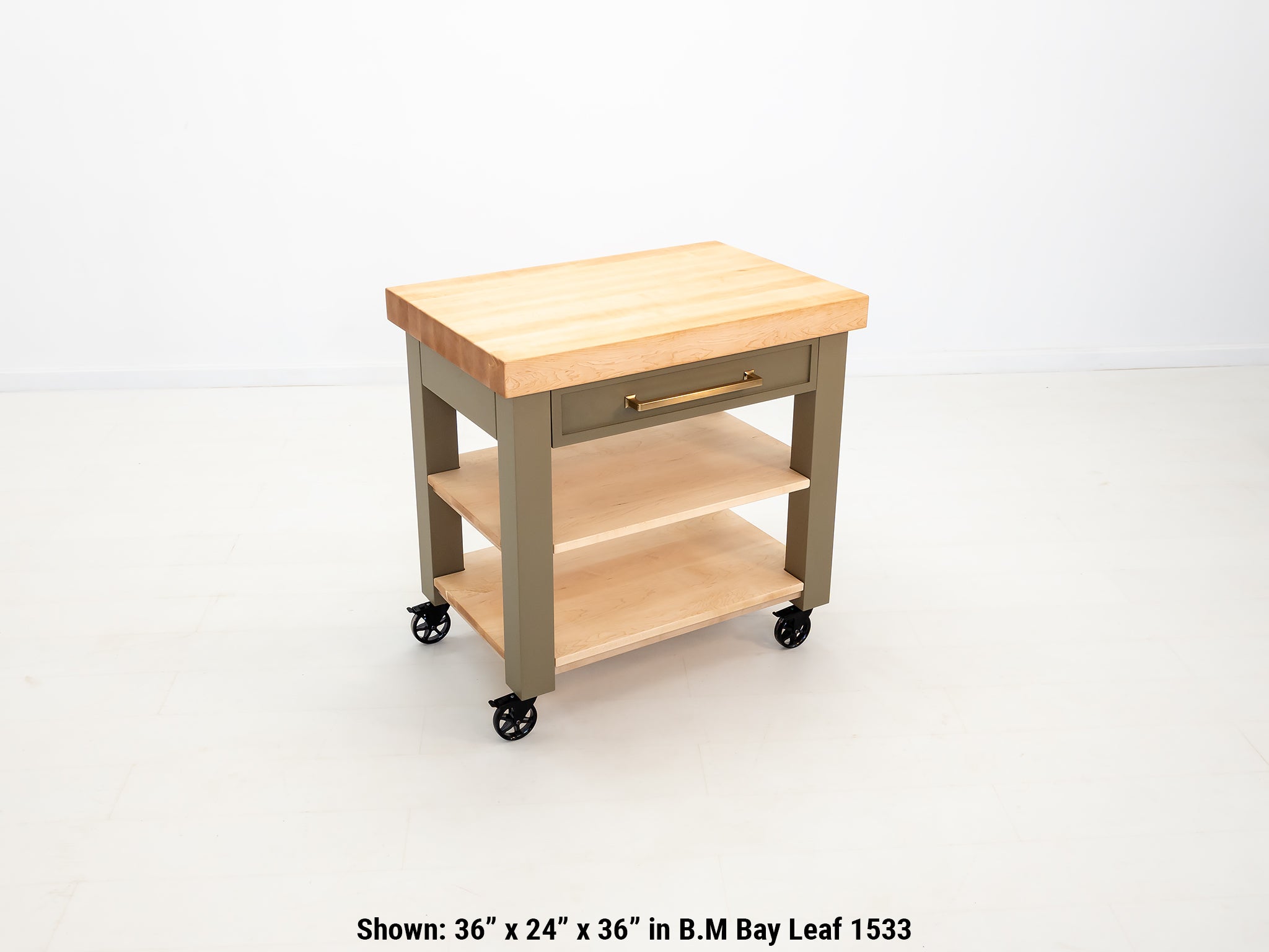 Rolling butcher block cart with inset drawer and locking casters.