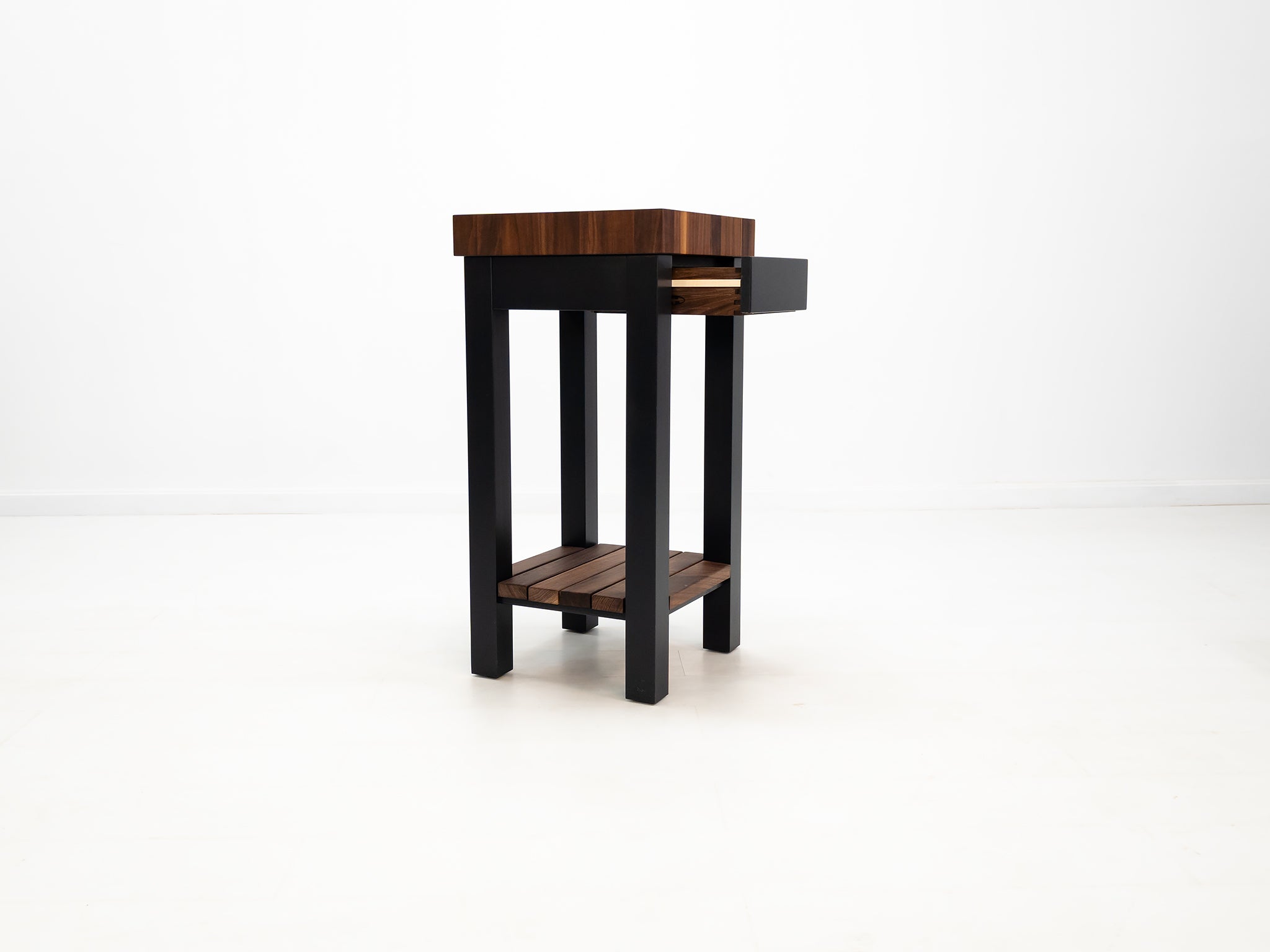 Compact walnut prep island with 3-inch thick butcher block surface.