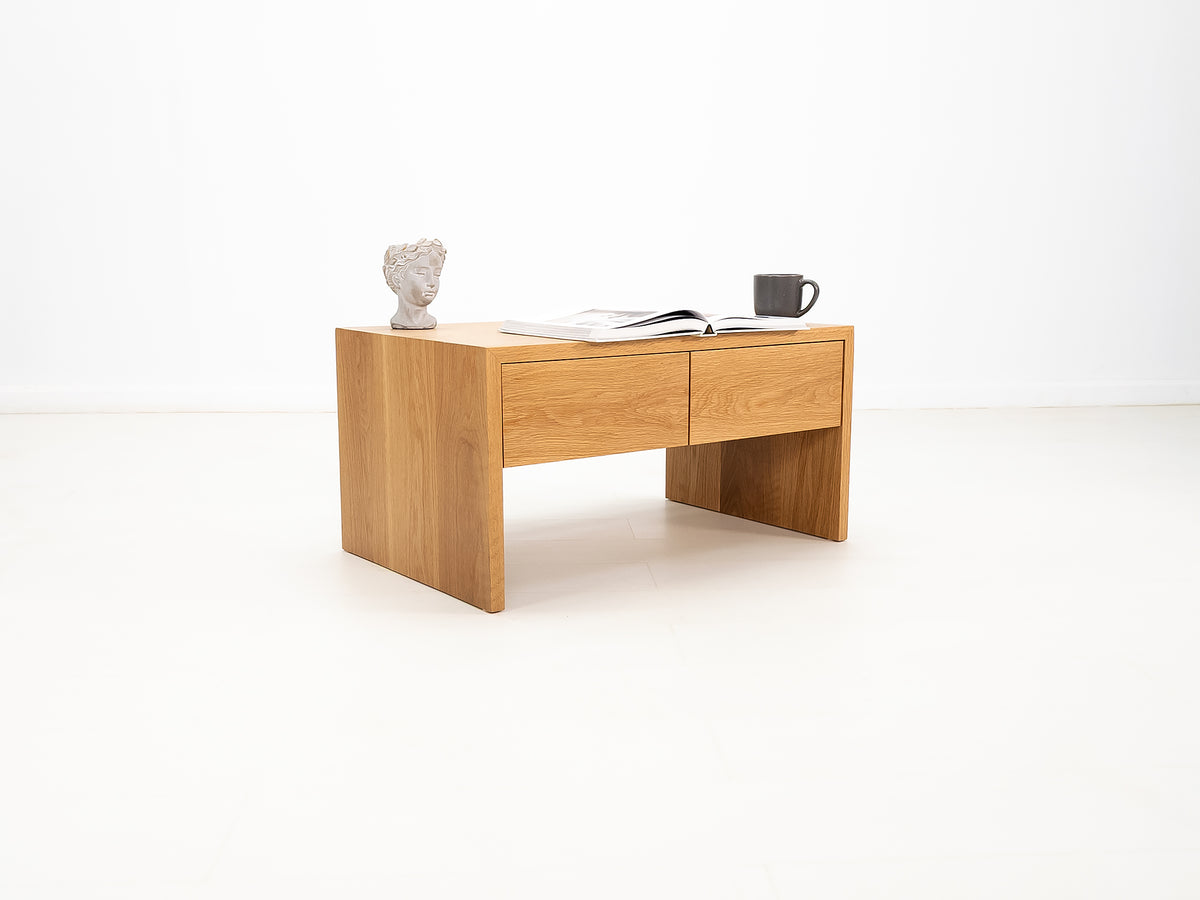 DREW coffee table in white oak with waterfall edge and soft-close drawers.