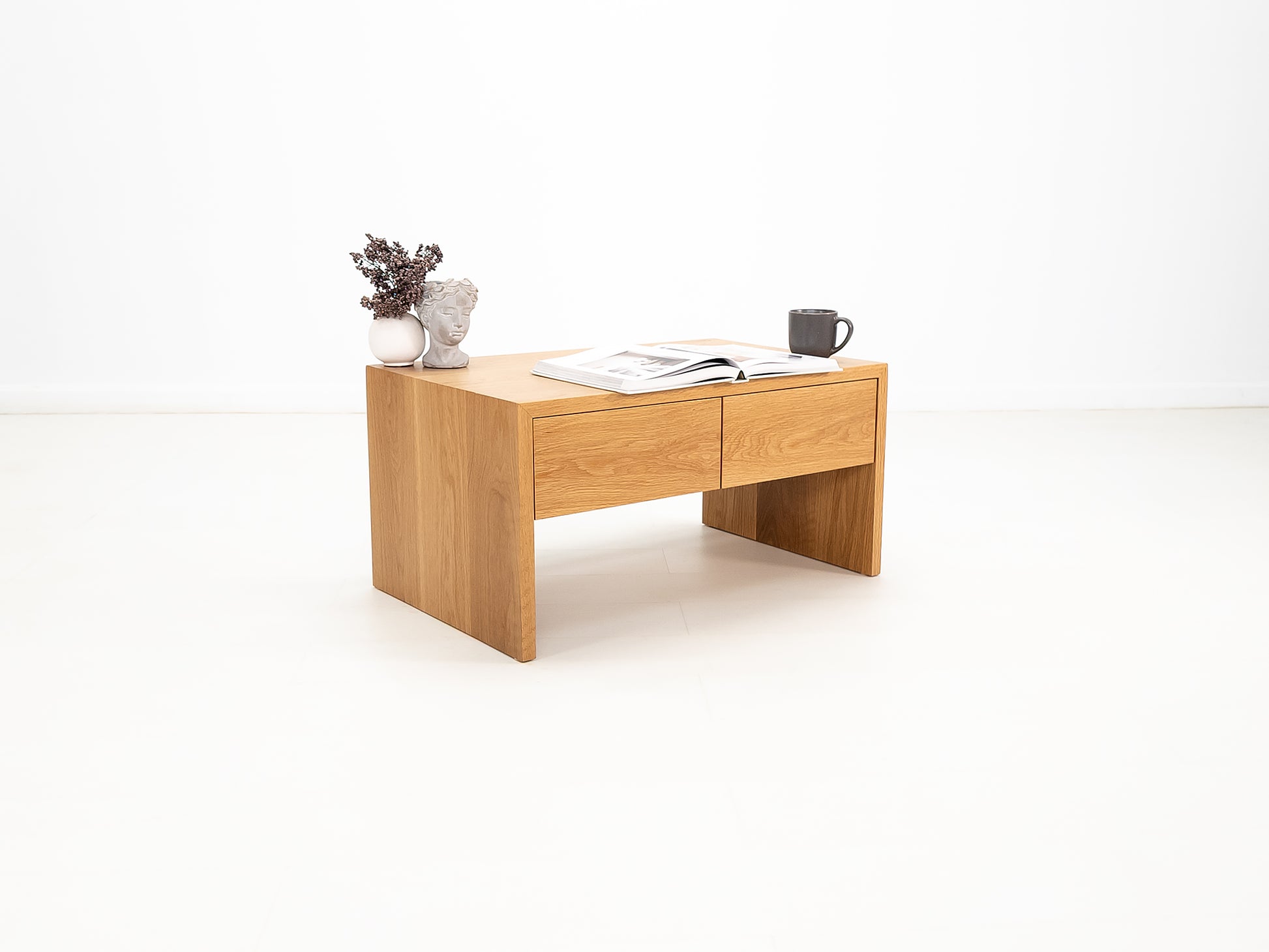 DREW coffee table in white oak with waterfall edge and soft-close drawers