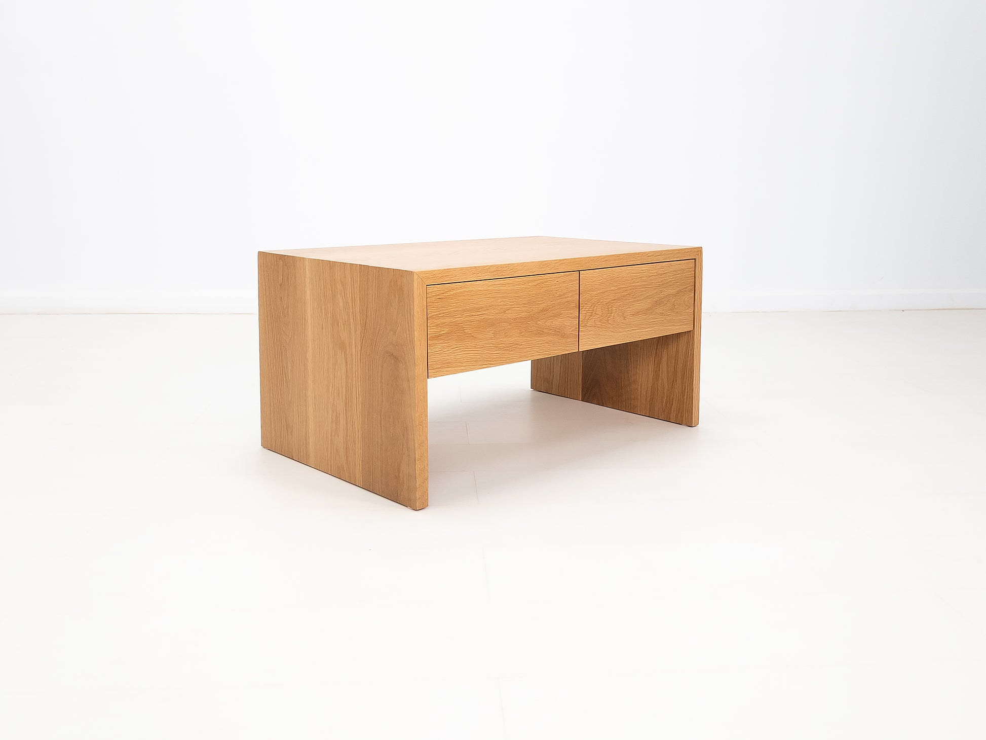 DREW coffee table in white oak with waterfall edge and soft-close drawers