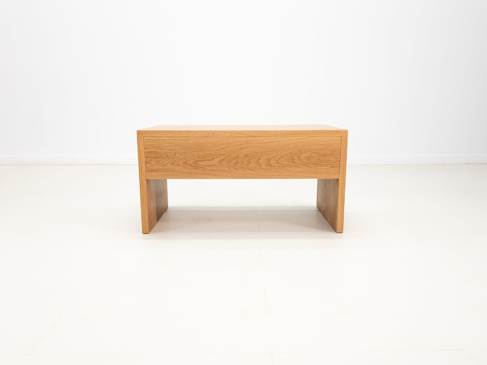 Side profile of DREW coffee table in solid white oak.