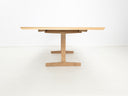BRIT trestle dining table in natural white oak, shown with beveled edge top.
