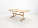 BRIT trestle dining table in natural white oak, shown with beveled edge top.