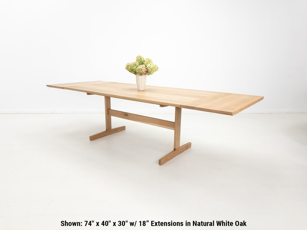 BRIT trestle dining table in natural white oak, shown with beveled edge top.