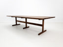 Angled view of oiled walnut BRIT table in white studio setting.