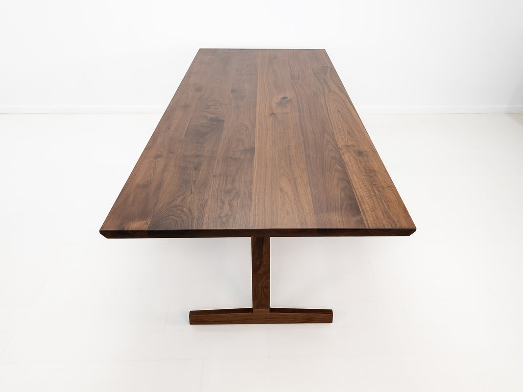 Close-up of beveled walnut tabletop with smooth, hand-finished edge.