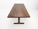 Close-up of beveled walnut tabletop with smooth, hand-finished edge.