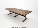 BRIT trestle dining table in oiled walnut, shown with beveled edge top and hardwax oil finish.
