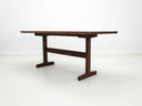Walnut trestle table with smooth, hand-finished edge.