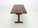Close-up of beveled walnut tabletop with smooth, hand-finished edge.