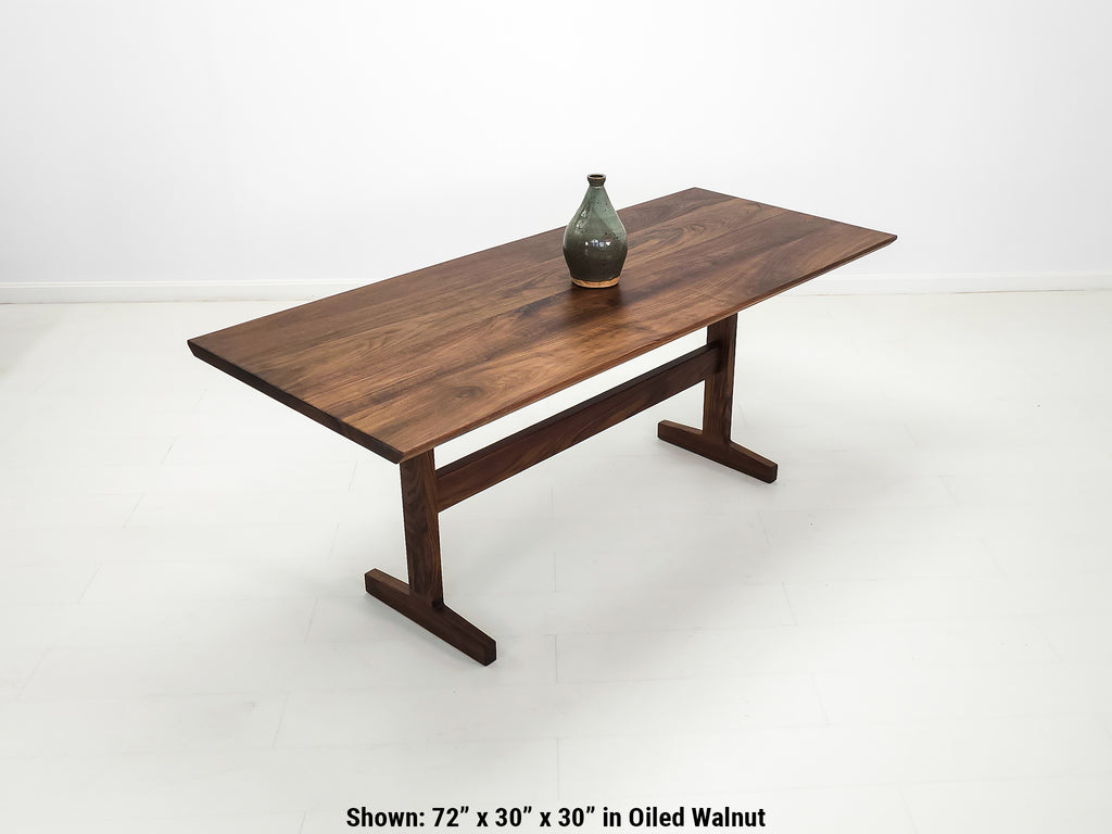 Close-up of beveled walnut tabletop with smooth, hand-finished edge.
