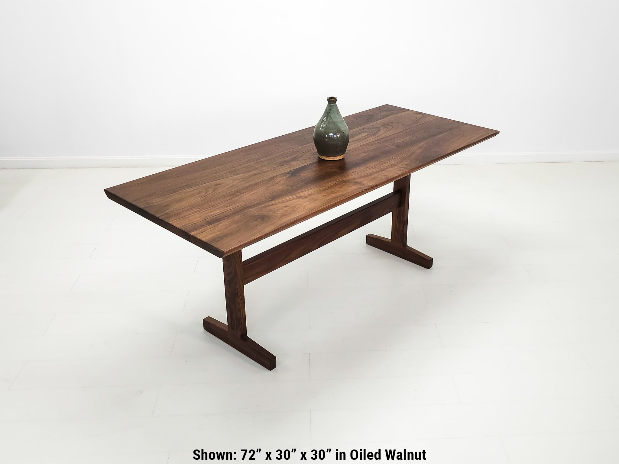 Close-up of beveled walnut tabletop with smooth, hand-finished edge.