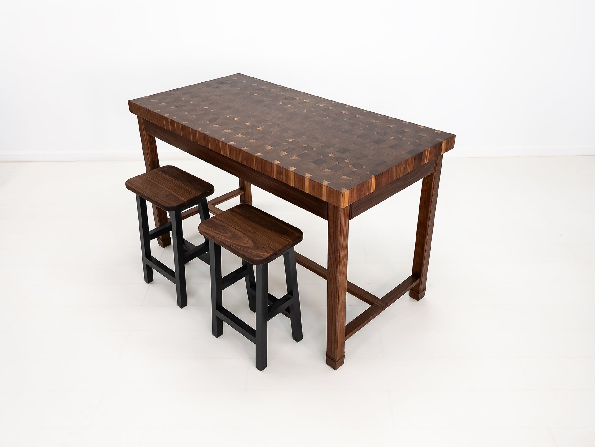 CAMI butcher block island in solid walnut with end-grain top and stretcher base.