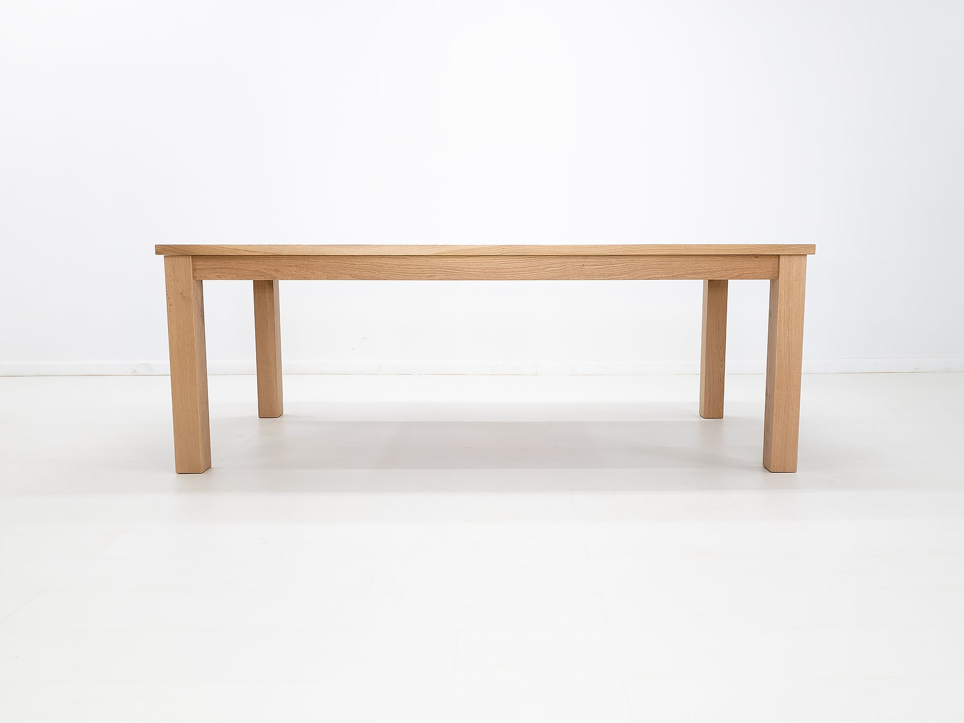JONA dining table in solid American hardwood, side view.