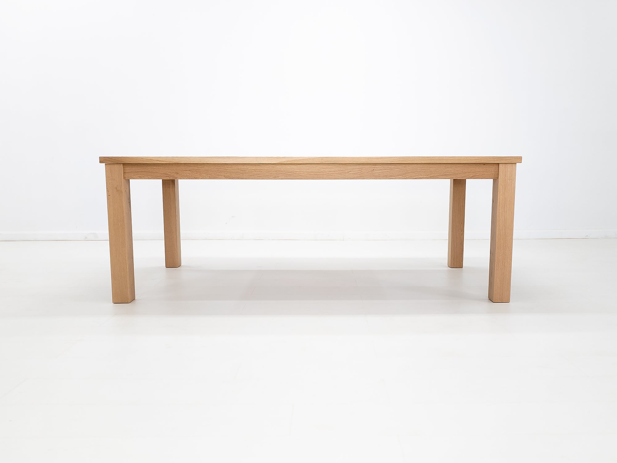 JONA dining table in solid American hardwood, side view.