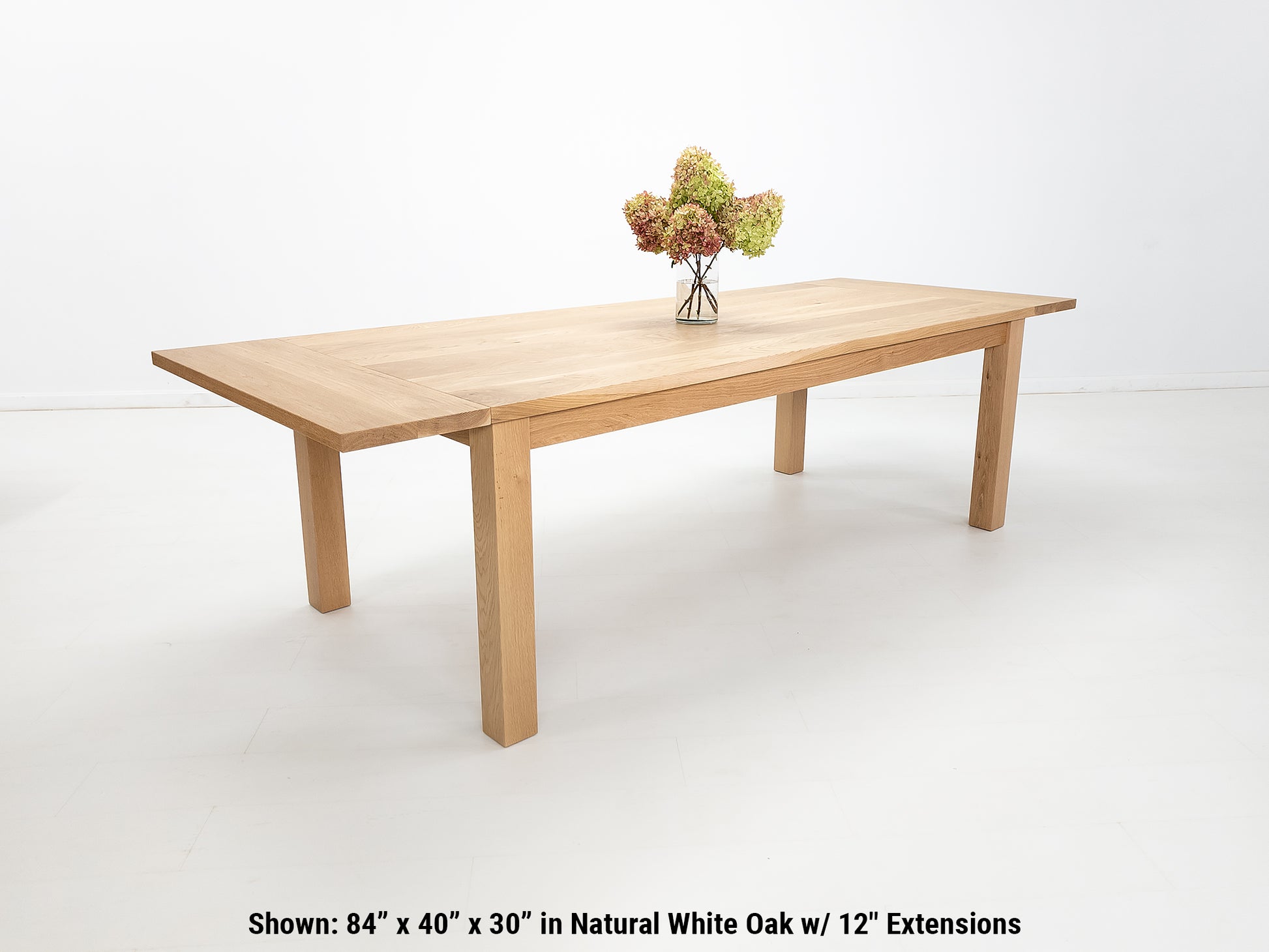 JONA dining table in natural white oak, angled view.