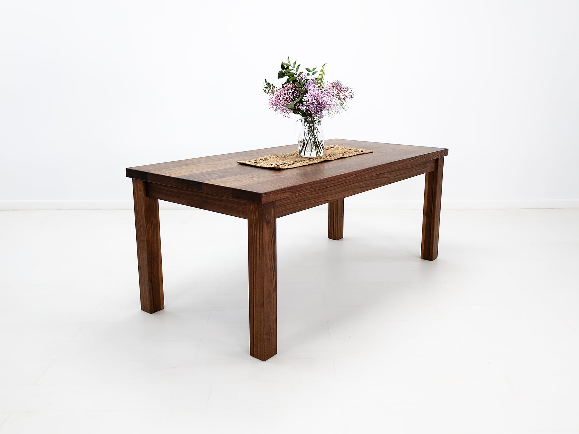 JONA dining table in oiled walnut with square legs.