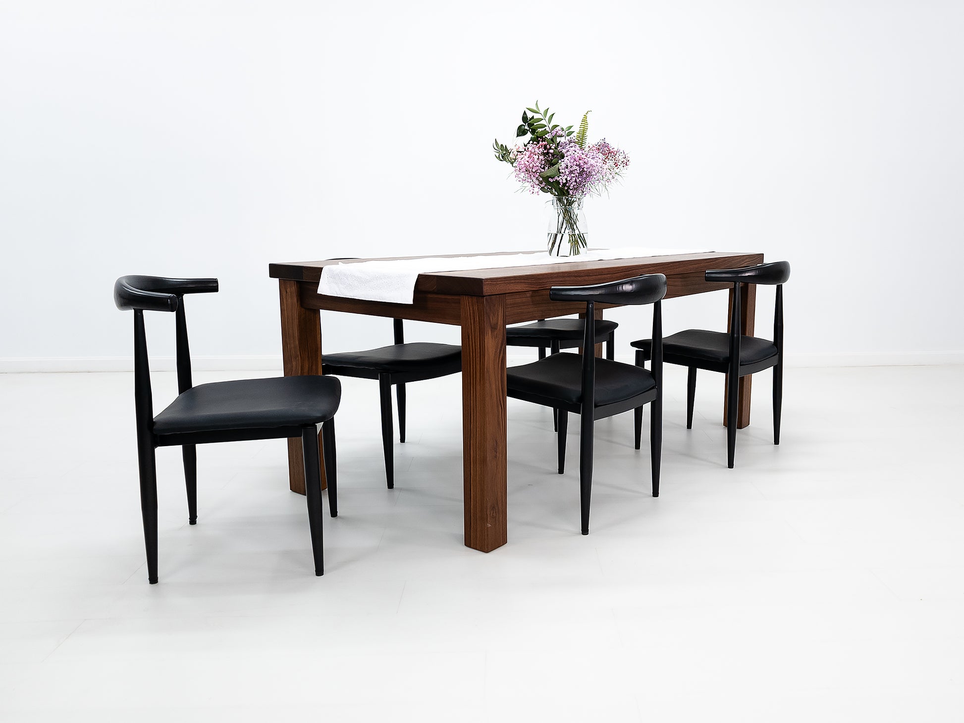 JONA dining table in oiled walnut with square legs.