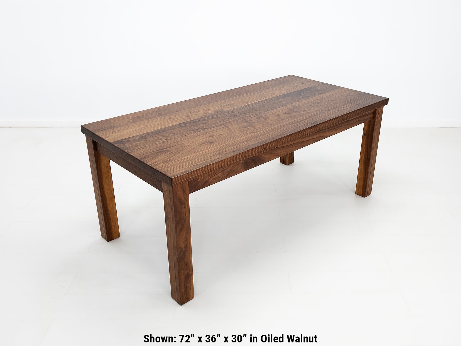 JONA dining table in oiled walnut with square legs.