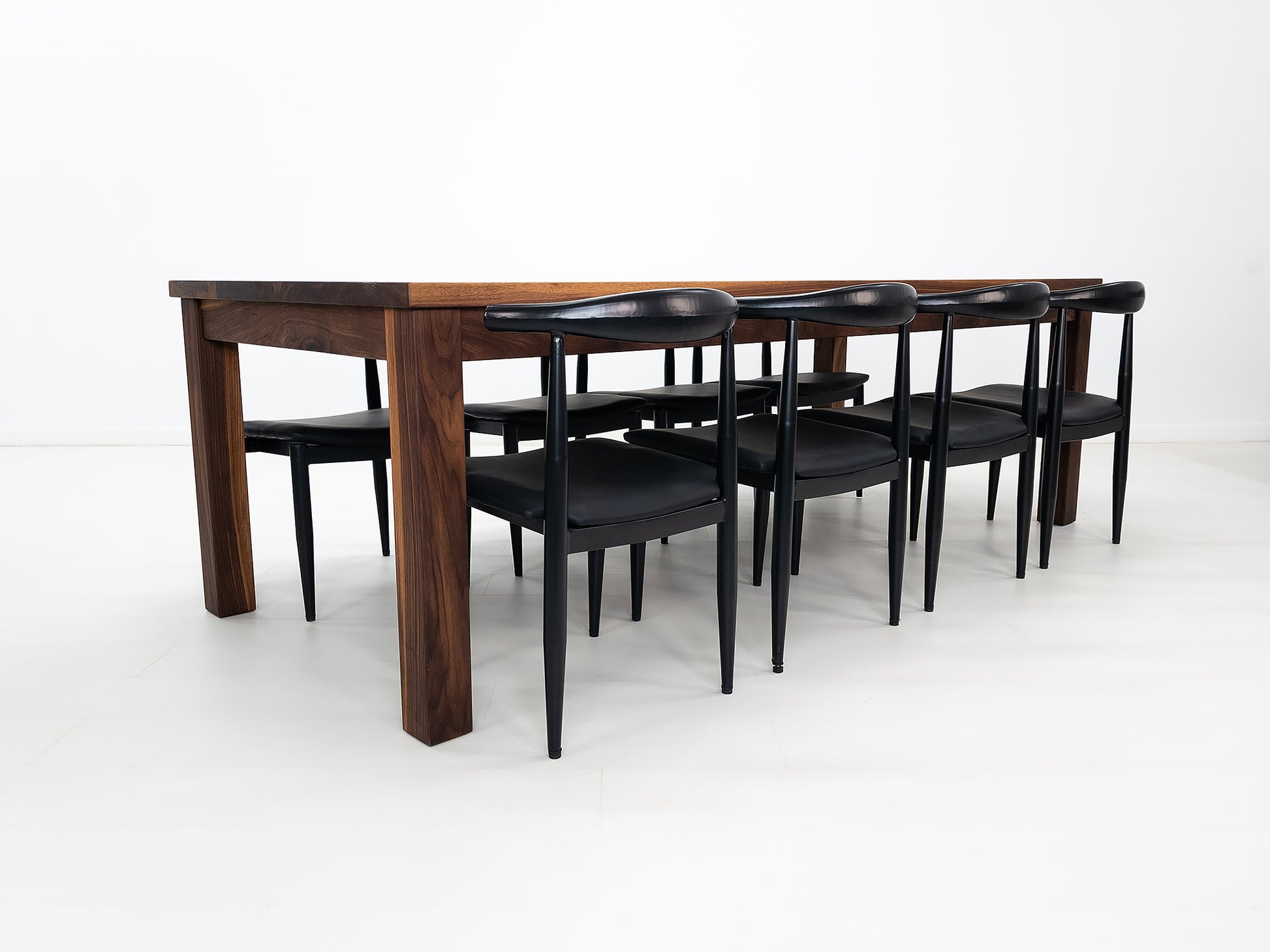JONA dining table in oiled walnut with square legs.