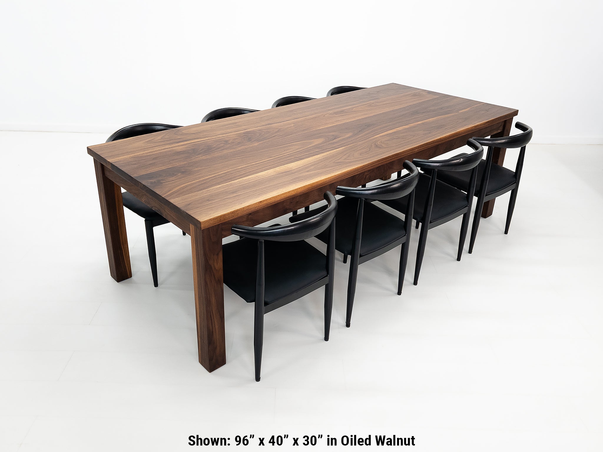 JONA dining table in oiled walnut with square legs.