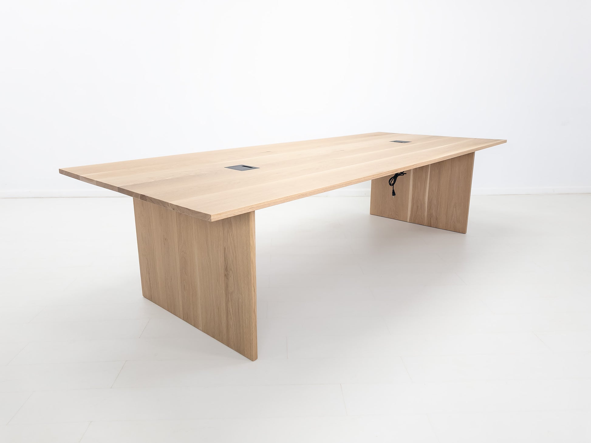Lily dining table in natural white oak with 1-inch thick top and clean plank grain.