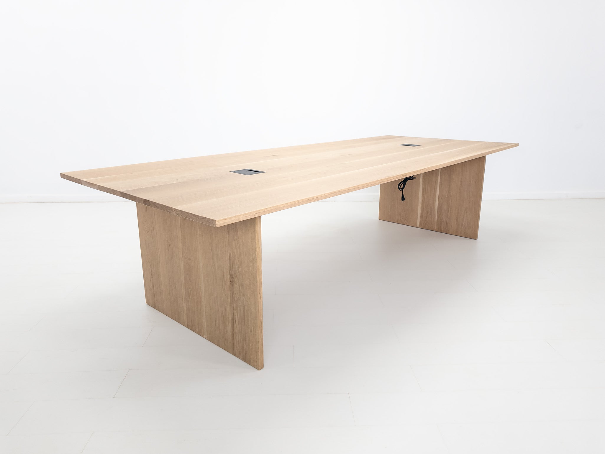 Lily dining table in natural white oak with 1-inch thick top and clean plank grain.