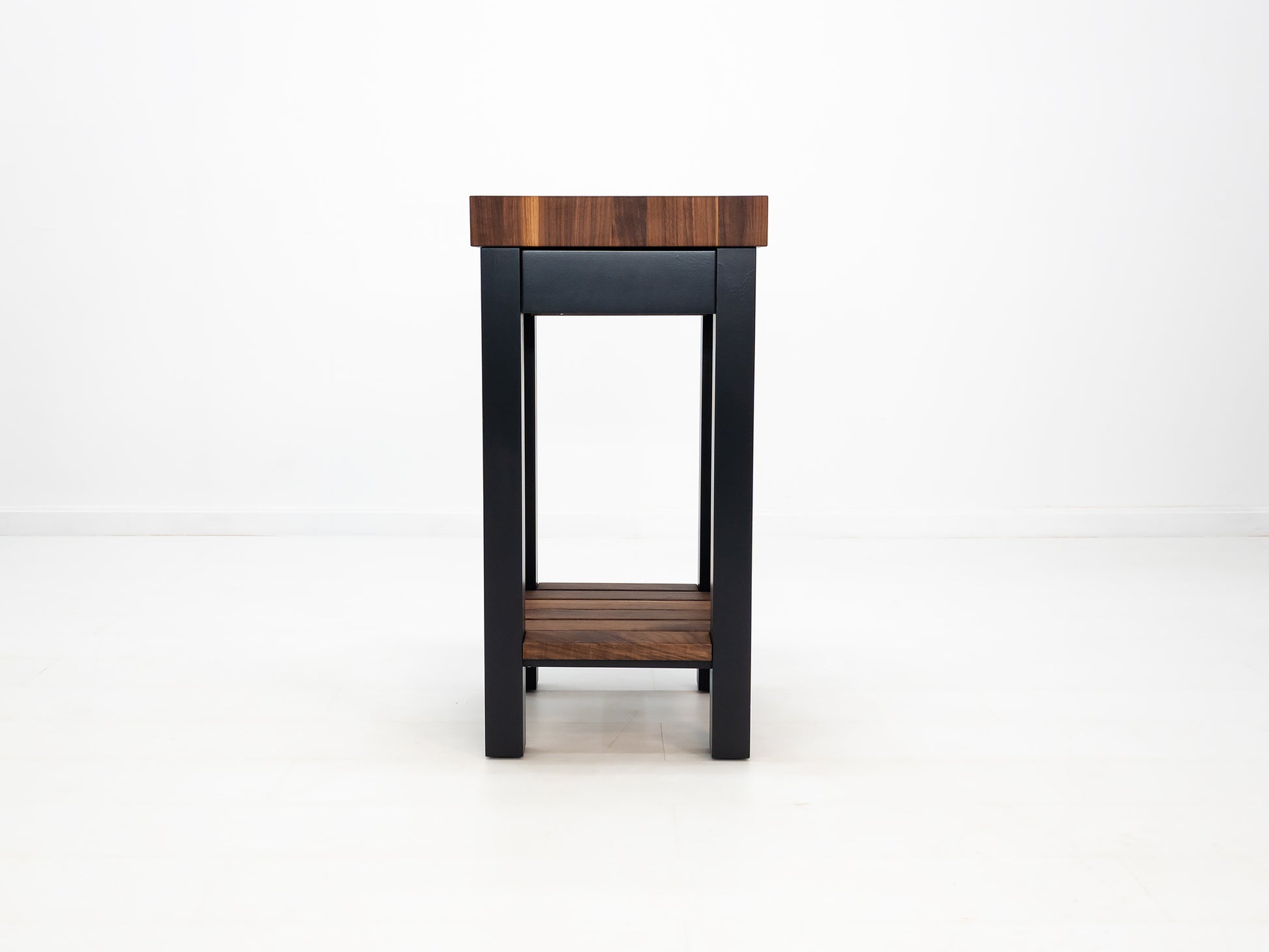 LUCA kitchen island with end-grain walnut butcher block top and slatted shelf.