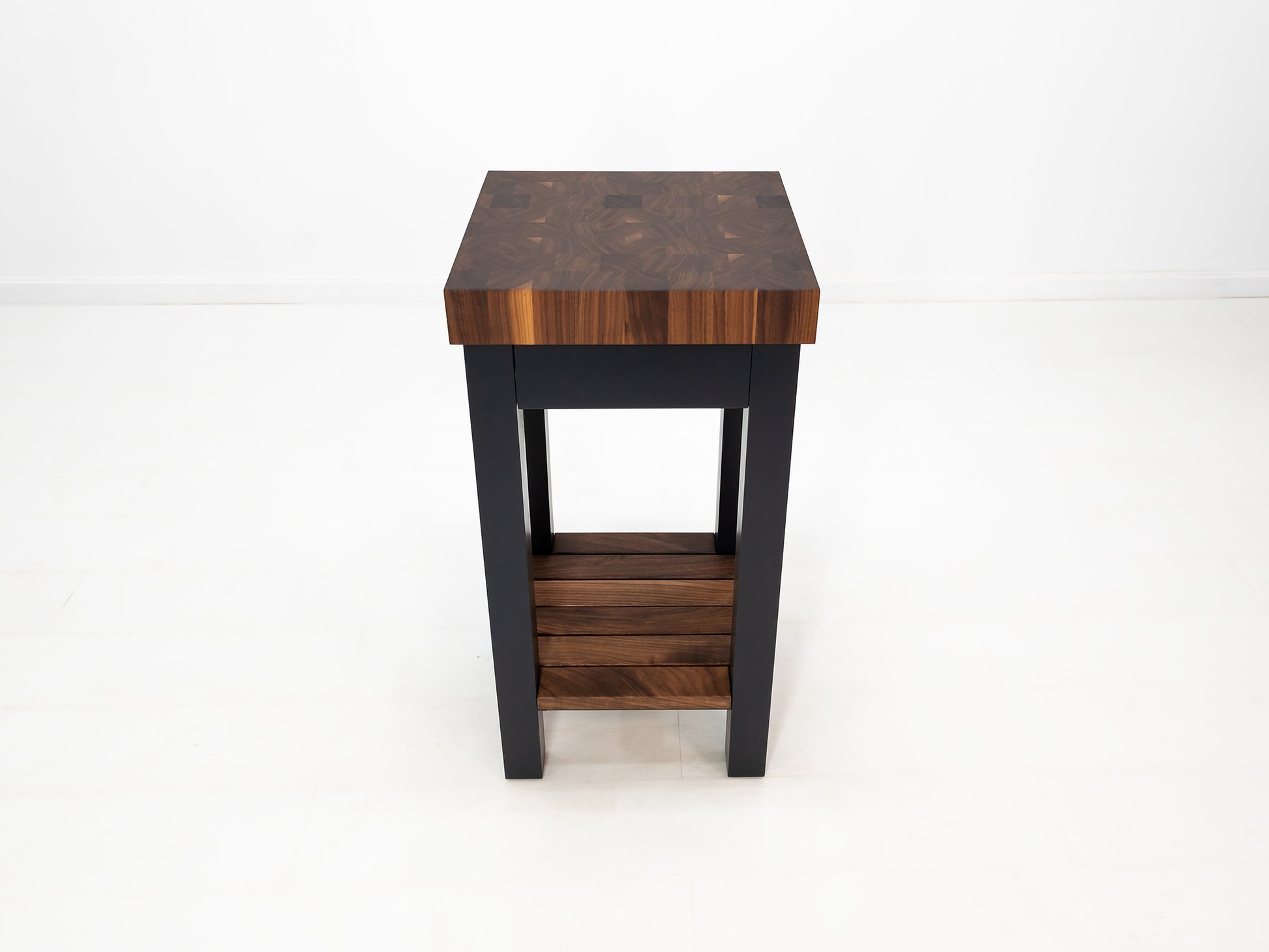 LUCA kitchen island with end-grain walnut butcher block top and slatted shelf.