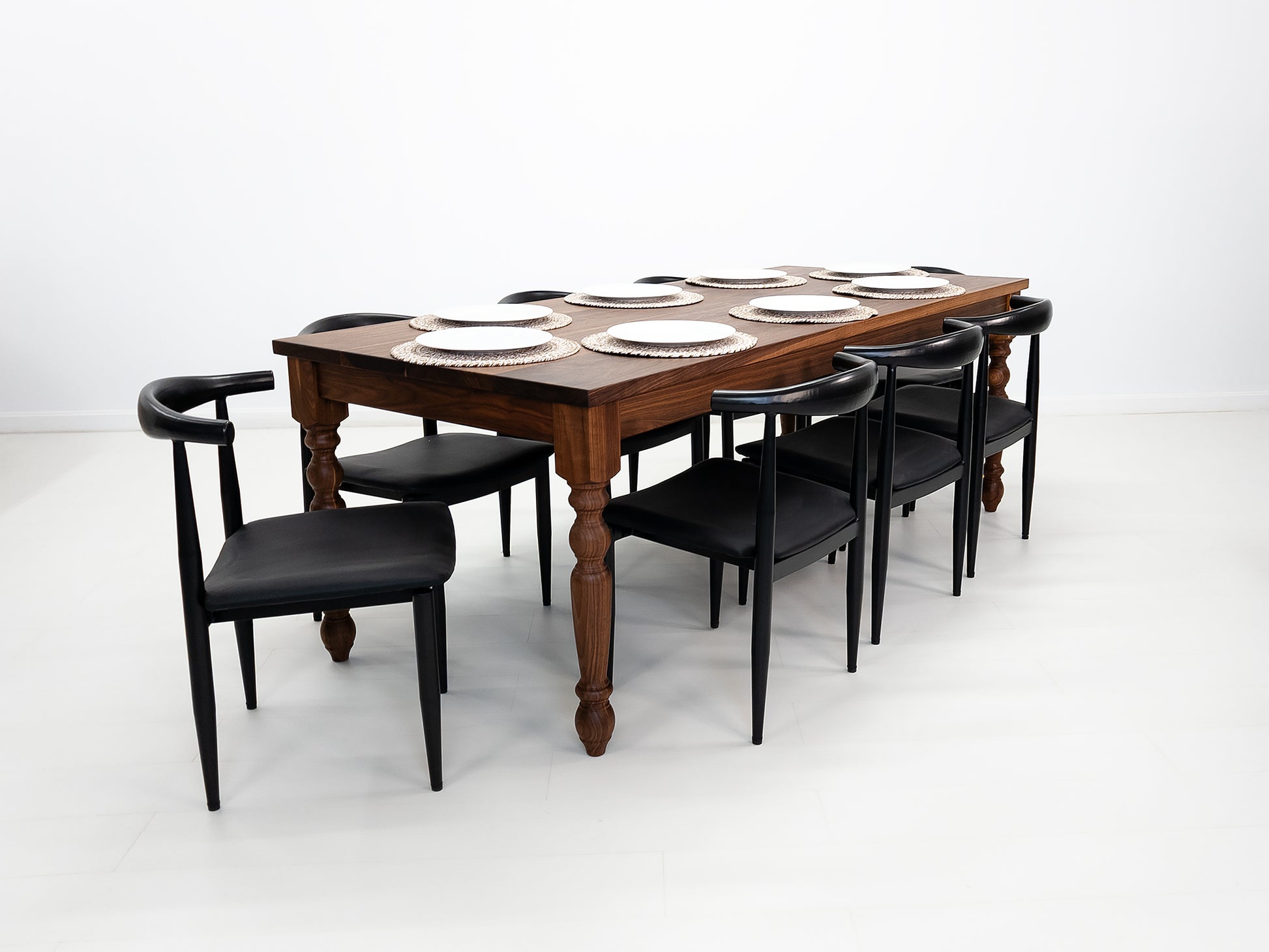 Handcrafted walnut dining table with classic turned legs.