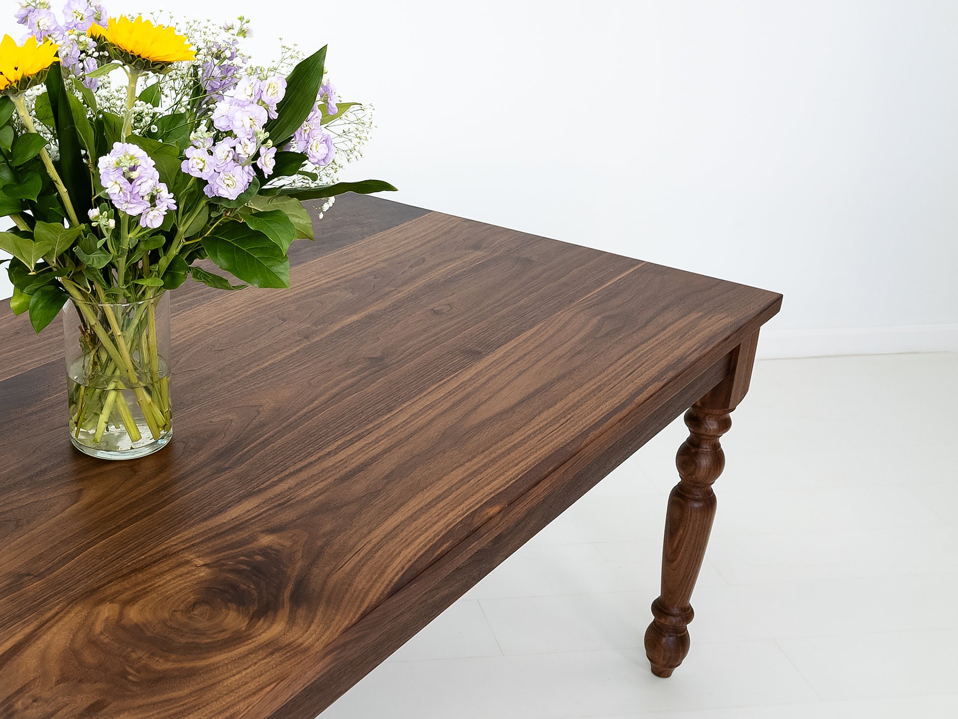 Close up of an oiled walnut TESS dining table.