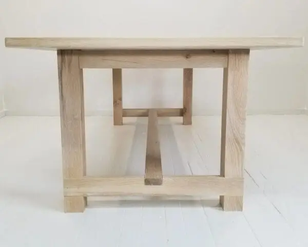 A seawashed white oak trestle dining table.