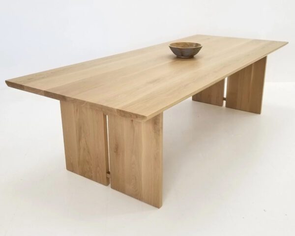 A DIVI Dining Table with Split Panel Legs with a bowl on top of it.