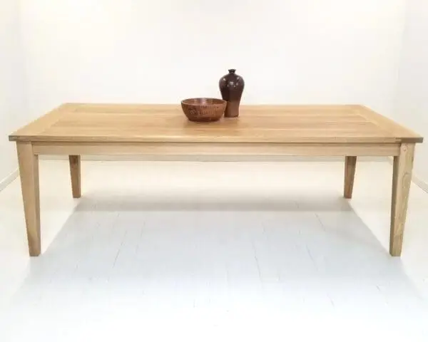 A tapered leg dining table with vases on top of it.