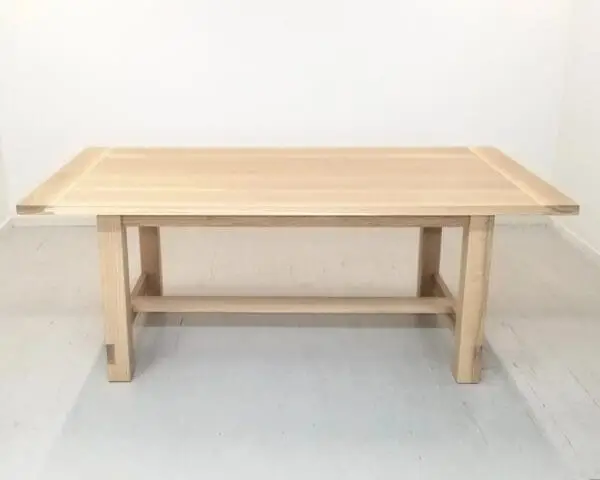 A white oak trestle dining table.