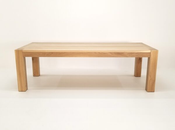 A JAQI Colossal Leg Parsons dining table on a white background.