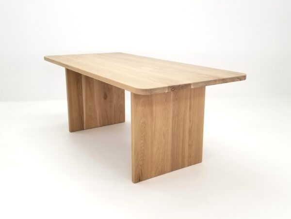 A TIAN Dining Table with Rounded Corners with a wooden base.