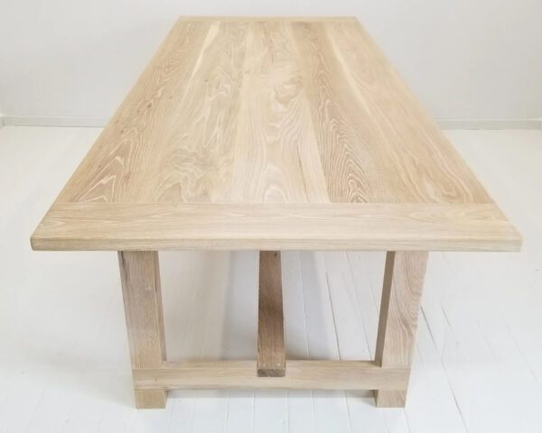 A seawashed white oak trestle dining table.