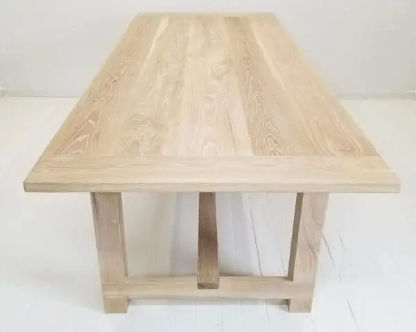 A seawashed white oak trestle dining table.