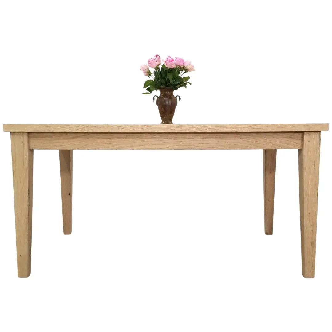 A ESME Tapered Leg Dining Table with a Plank Top made of oak with flowers in a vase.