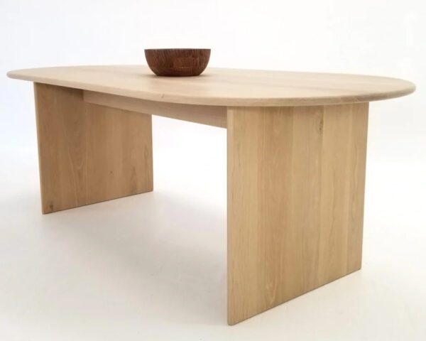 A wooden dining table with a bowl on top of it.