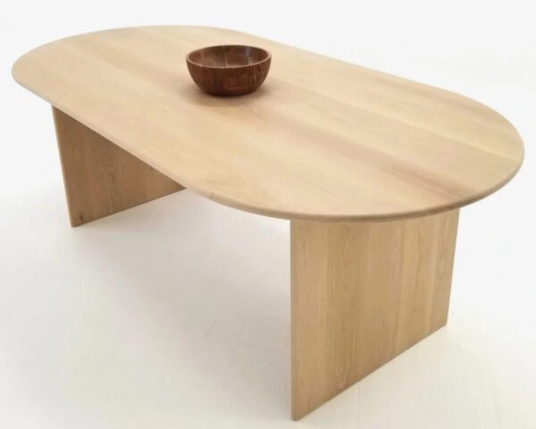 A wooden dining table with a bowl on top of it.