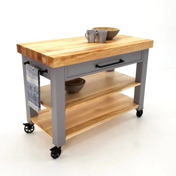 A grey butcher block cart with shelves and mugs on top.