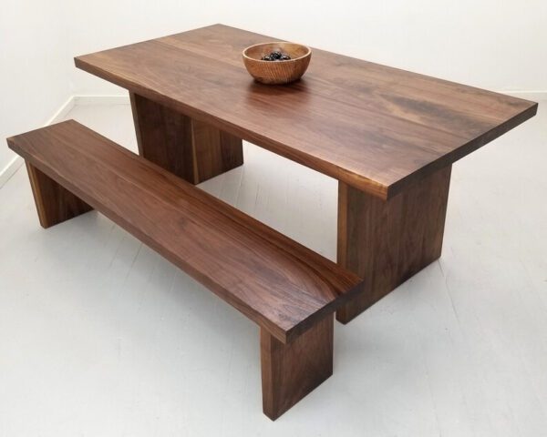 A 2 inch thick solid walnut dining table with a bowl on top of it.