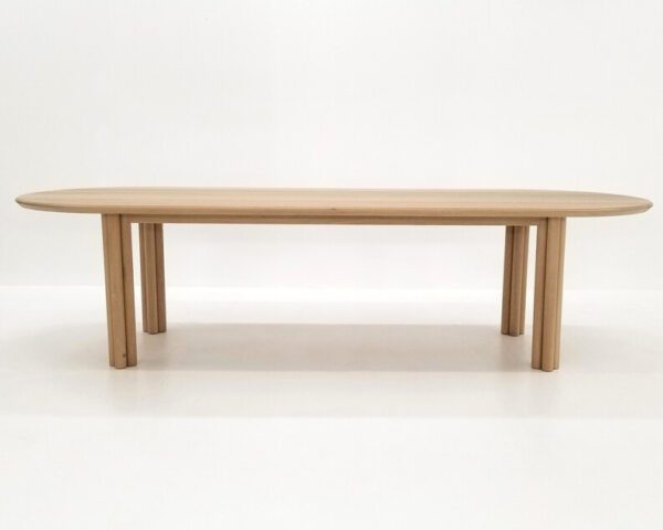 A white oak dining table with cylinder legs.