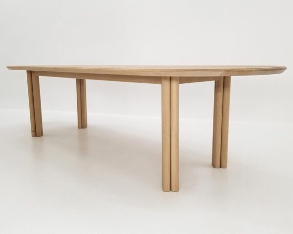 A white oak dining table with cylinder legs.