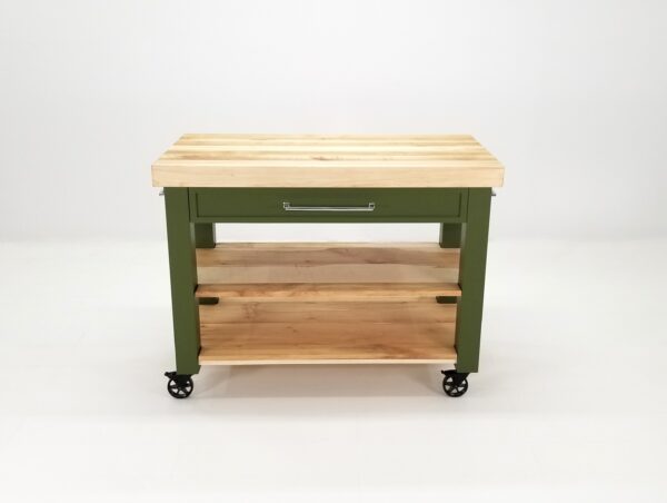 A green butcher block kitchen island with shelves underneath it.